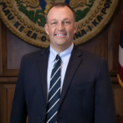 Headshot of Hawai’i governor Josh Green smiling. 